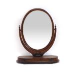 A Victorian walnut dressing table mirror, the oval plate on a platform base, h.