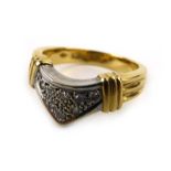An 18ct yellow gold ring pave set small diamonds in a v-shaped setting within a reeded band,