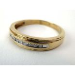 A 10ct yellow gold ring set small diamonds in a tension channel-type setting, ring size S, 3.