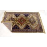 An early 20th century woolen rug with a red ground,