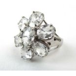 A 9ct white gold dress ring set clear stones in a flowerhead setting, ring size N, 5.