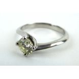 A platinum crossover ring set brilliant cut diamond in a four claw setting, stone approximately 0.