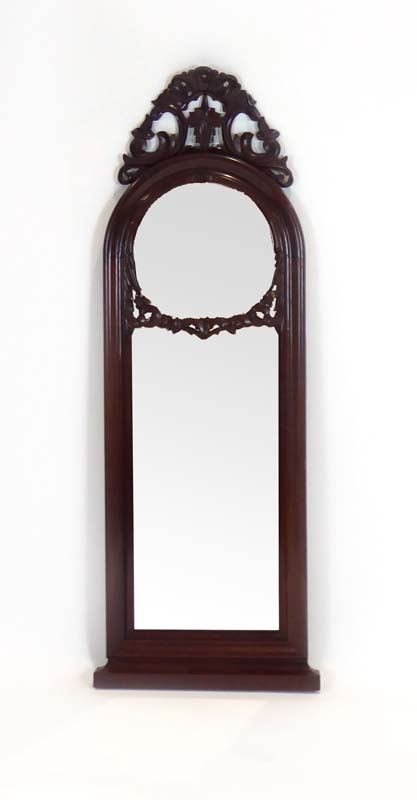 A mahogany mirror, the domed top surmounted by a foliate finial, h.