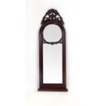 A mahogany mirror, the domed top surmounted by a foliate finial, h.
