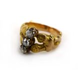 A yellow metal ring set three small diamonds within a twisted branch design setting, ring size H, 4.