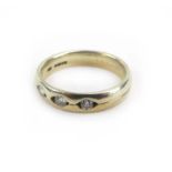 A 9ct two colour band ring inset three small diamonds, ring size L, 3.