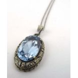 An 18ct white gold boxlink necklace suspending a silver pendant of oval form set pale blue glass,