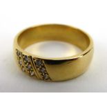 An 18ct yellow gold wedding band set three rows of small diamonds, ring size R 1/2, 6.