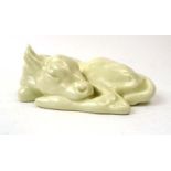 Raoh Schorr for Royal Doulton, a model of a sleeping/laying calf decorated in a plain cream glaze,