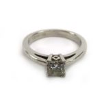 A platinum ring set princess cut diamond in a four claw setting, stone approximately 0.