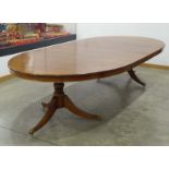 A walnut twin-pedestal dining table, with two fitted leaves, max. l.