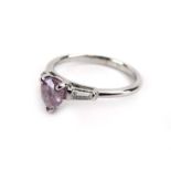 An 18ct white gold ring set pear shaped fancy pink/purple diamond in a three claw setting,