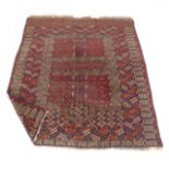 A late 19th/early 20th century rug, the red ground decorated with a Tekke-type pattern,