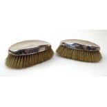 A pair of early 20th century silver backed oval brushes, Birmingham hallmarks rubbed, l.