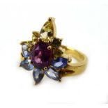 An 18ct yellow gold gem set ring of flowerhead design, ring size N, 6.