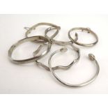 Six silver and metalware hinged and cuff bracelets of varying design CONDITION REPORT: