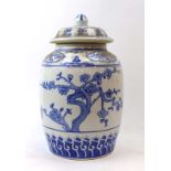 A modern Chinese blue and white jar and cover of ovoid form typically decorated with pine trees and