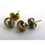 A pair of two colour ear studs of knot design, overall 1.