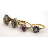 A group of four 9ct yellow gold and yellow metal dress rings set small diamonds and rubies,