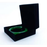 A green jade bangle, internal d. 6.