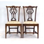 A pair of late 18th century carved oak dining chairs with drop-in seats