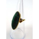 An 18ct yellow gold ring set cabochon malachite and two small diamonds in a diagonal setting,