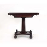 A Regency mahogany tea table, the folding surface over a turned column,