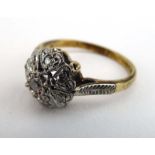 An 18ct yellow gold cluster ring set seven small diamonds in heart shaped settings,