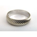 A 9ct white gold wedding band with chevron engraved decoration, hallmarked for London 1978,