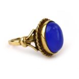 A 9ct yellow gold ring set cabochon lapis-type stone within a ropetwist border, ring size P 1/2, 4.