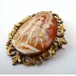 A yellow metal mounted cameo brooch of oval form centrally depicting the three graces, l. 7.