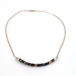 A 9ct yellow gold fine chainlink necklace suspending a curved pendant of tortoiseshell design, l.