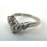 A platinum ring set seven marquise cut diamonds in a v-shaped setting,