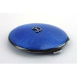 A silver and pale blue gillouche enamelled compact of circular form,