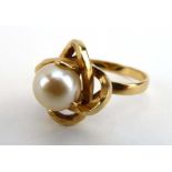 A French yellow metal ring set cultured pearl in an entwined setting, ring size N, 2.