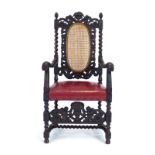 A carved oak armchair with a bergere back and a red leather seat over a shaped apron