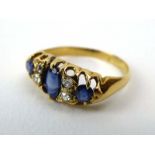 A late 19th century 18ct yellow gold ring set three graduated sapphires interspersed with four