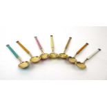A set of seven early 20th century Norwegian silver gilt and enamel decorated coffee spoons,