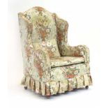 A late 19th/early 20th century and later wingback armchair with mahogany feet and castors