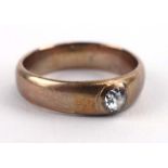 A gentleman's yellow metal band ring set old cut diamond in a recessed rubover setting,