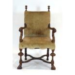 A 19th century Continental oak and upholstered armchair with a cross stretcher