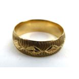 A 9ct yellow gold engraved wedding band, hallmarked for London 1974, ring size P, 3.