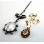 An early 20th century metalware pendant necklace of Arts & Crafts design set mother of pearl and