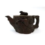 A Chinese Yixing novelty stoneware teapot with squirrel finial and pine tree body,