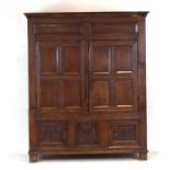 An early 18th century and later oak armoire, w.