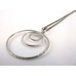 An 18ct white gold boxlink necklace suspending an 18ct white gold pendant of circular form, d.