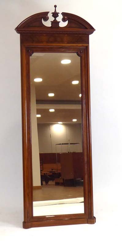 A late 19th/early 20th century walnut and ebony strung pier mirror with an architectural pediment,