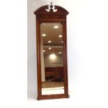A late 19th/early 20th century walnut and ebony strung pier mirror with an architectural pediment,