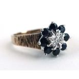 A 9ct yellow gold cluster ring set diamond and sapphires within a bark design shank, ring size K, 3.