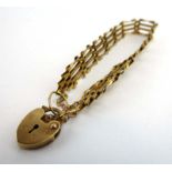 A 9ct yellow gold four bar gate link bracelet with heart shaped padlock clasp, 5.